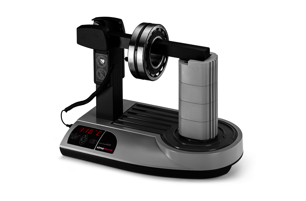 The simatherm IH 210 induction heater heats a deep groove ball bearing over the medium support yoke. The target temperature is set to 110 °C.